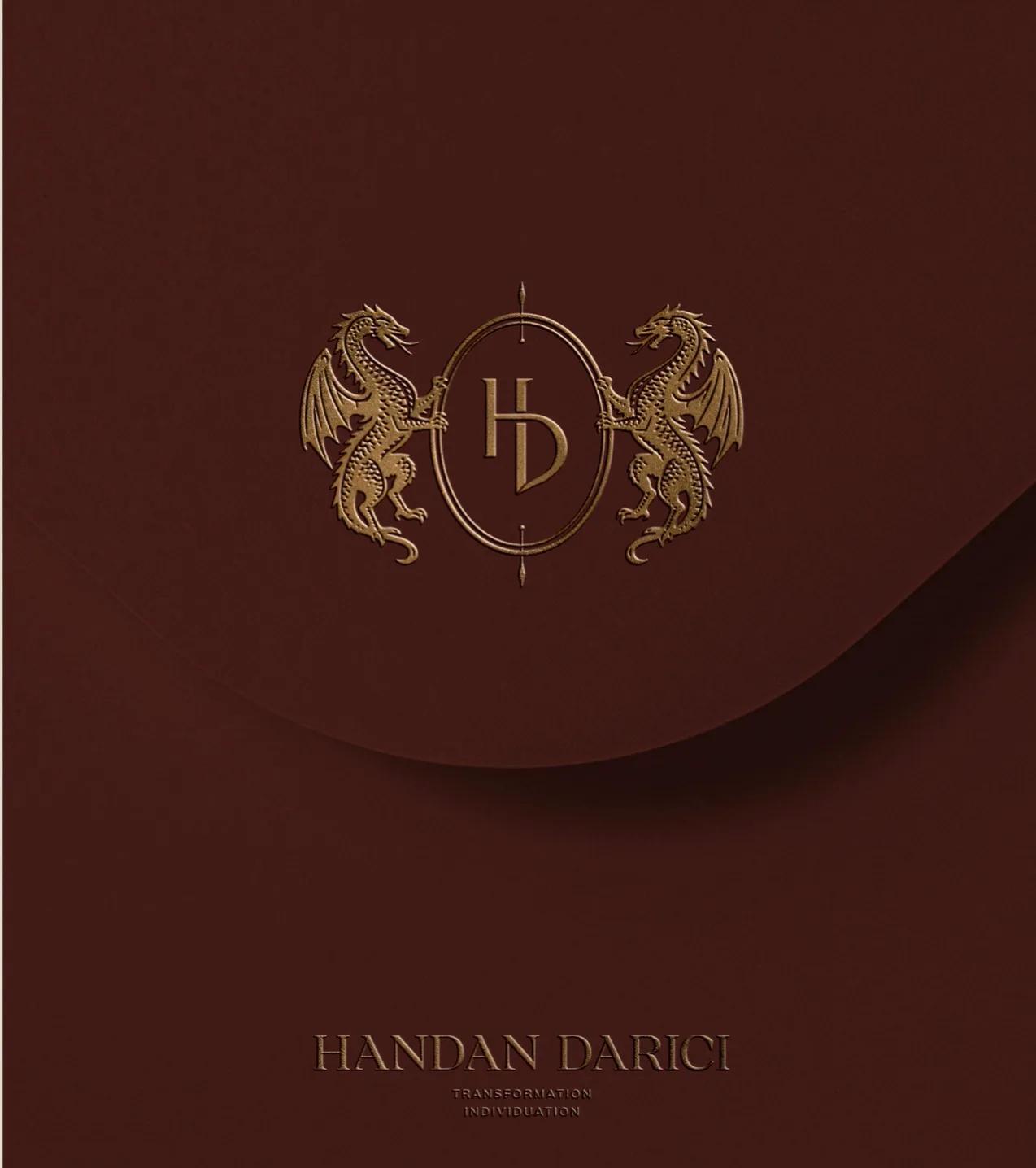 Handan Darici's gold dragon crest embossed on a deep merlot card